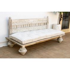 a white bench sitting on top of a tiled floor