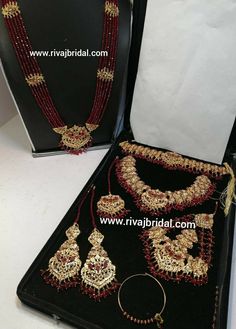 two necklaces and earrings on display in a box