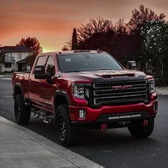 the red truck is parked on the side of the road