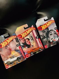 three hot wheels diecast cars are shown in this photo, one has a woman and the other is a man