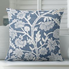 a blue and white pillow sitting on top of a table