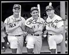 three baseball players are posing for a photo