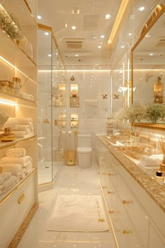 a large bathroom with gold accents and white tile walls, along with marble counter tops