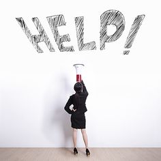 a woman standing in front of a white wall with the word help written above her head