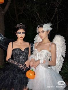 two women dressed in halloween costumes standing next to each other with pumpkins on their hands