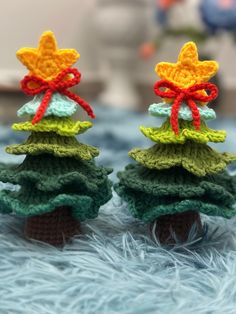 two crocheted christmas trees sitting on top of each other