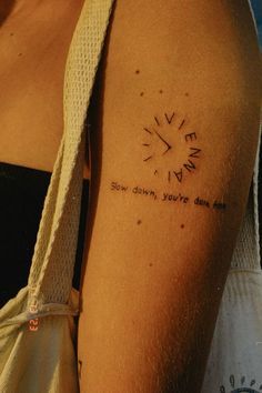 a woman with a tattoo on her arm that says, we don't have time