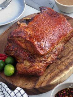 a large piece of meat sitting on top of a wooden cutting board