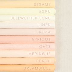 six different colored sheets sitting on top of each other with words written in white and pink