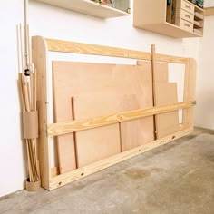 a room with some unfinished wood pieces on the floor and shelves above it that are made out of plywood