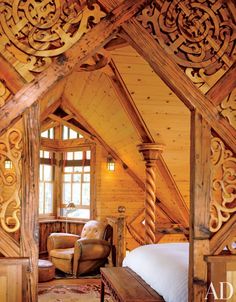 an attic bedroom with wooden walls and ceilings