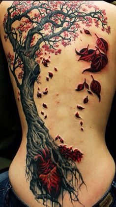 the back of a woman's body with red leaves on it and a tree