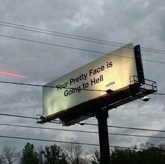 a billboard on the side of a pole that says your pretty face is going to hell