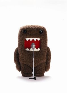 a stuffed animal with a microphone in front of it's mouth and teeth on its face