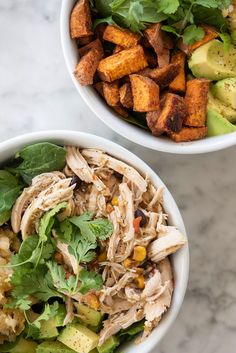 two white bowls filled with food on top of a marble counter next to each other