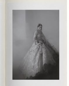 a black and white photo of a woman in a wedding dress