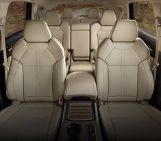 the interior of a car with beige leather seats