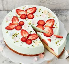 a white cake with strawberries on it and the words maiforte written in german