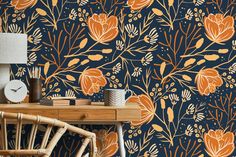 an orange and blue floral wallpaper in a room with a wooden table, chair and lamp