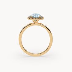 a yellow gold engagement ring with an oval blue topazte and two small diamonds