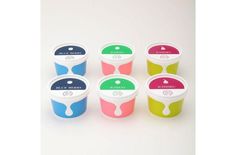 six ice cream cups with different colors and designs on them, all lined up in a row