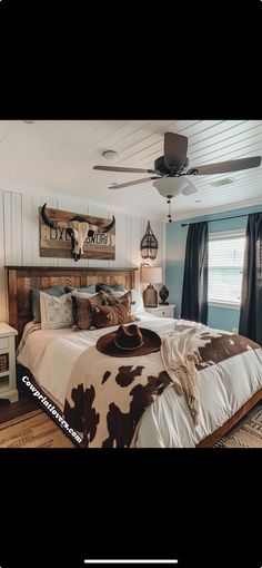 a bed room with a neatly made bed and a ceiling fan