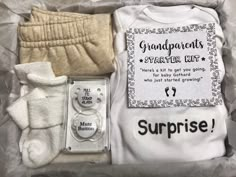 a baby gift box with an infant's outfit and other items