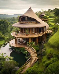 an aerial view of a house in the middle of a lush green area with stairs leading up to it