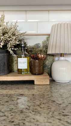 a table with two vases and a lamp on it