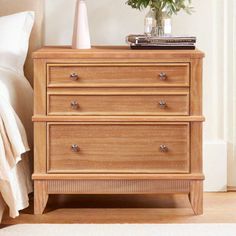 a wooden dresser with flowers on top of it