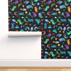 a black wall with colorful dinosaurs on it