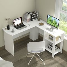 a computer desk with a laptop on top of it next to a chair and bookshelf