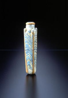 a blue and white vase sitting on top of a black table next to a wall