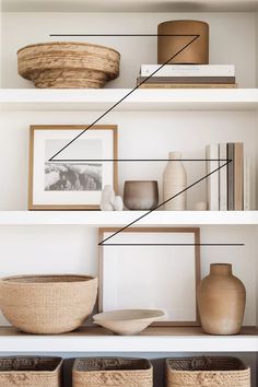 shelves with baskets, vases and pictures on them