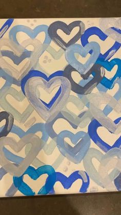 a painting with blue and white hearts on it