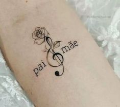 a tattoo with music notes and a rose on the arm that says pai ama