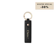 a black leather keychain with the word, winter special 30 % off on it