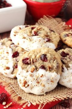 cranberry pecan cookies with white frosting on a burlap cloth