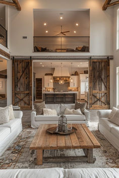 a living room filled with white couches and wooden tables