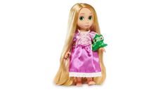 a doll with long blonde hair wearing a pink dress and holding a frog in her hand