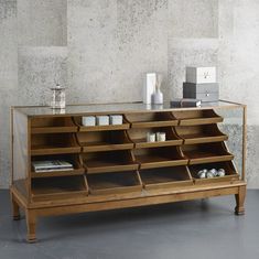 a wooden shelf with several compartments on it