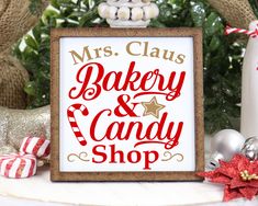 a sign that says mrs claus bakery and candy shop on it next to christmas decorations