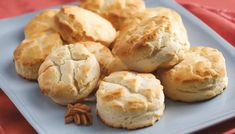 a blue plate topped with biscuits and star anise on top of a red cloth