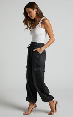 Hanabi Cargo Parachute Pant in Black | Showpo USA Black Cargo Pants Summer Outfit, Summer Parachute Pants Outfit, Parachute Pants Outfit Black Women, Chic Streetwear Parachute Pants With Pockets, Urban Style Summer Parachute Pants With Elastic Waistband, Chic Parachute Pants For Streetwear With Pockets, Urban Parachute Pants With Elastic Waistband For Summer, Chic Spring Streetwear Cargo Pants, Chic High Waist Parachute Pants For Streetwear