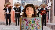 a woman holding up a sign with the words happy birthday written on it in front of her