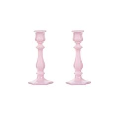 two pink candlesticks sitting next to each other