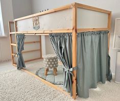 a wooden bunk bed with curtains on the top and bottom