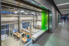 an office building with lots of desks and computers