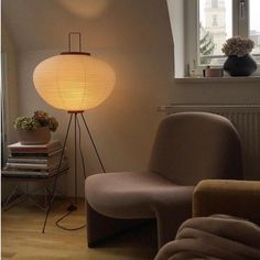 a living room with a chair and lamp in it