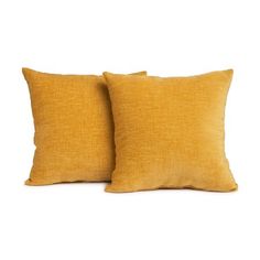 two yellow pillows sitting next to each other